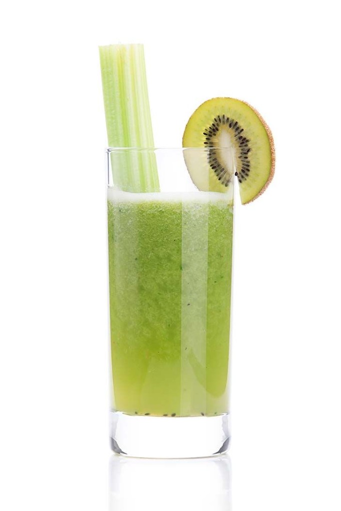 a glass of kiwi smoothie and celery